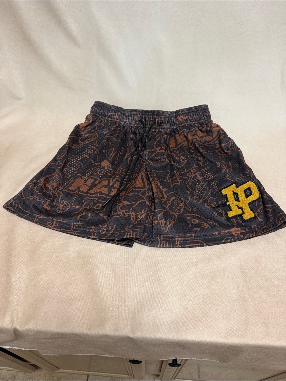 Inaka Power Black Shorts with Brown Doodle Print and Yellow 'P' Patch